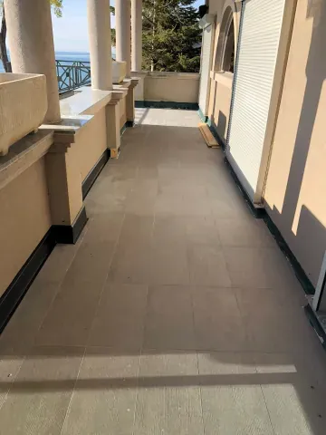 Large-format floor tiles on a covered balcony