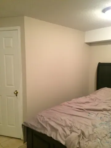 Finished basement bedroom with a recessed ceiling bulkhead