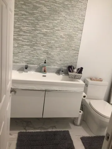 Bathroom vanity and mosaic tiled wall