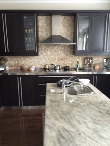 Dark kitchen cabinetry and stone island countertop
