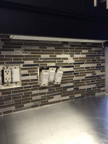 Mosaic kitchen backsplash during outlet finishing