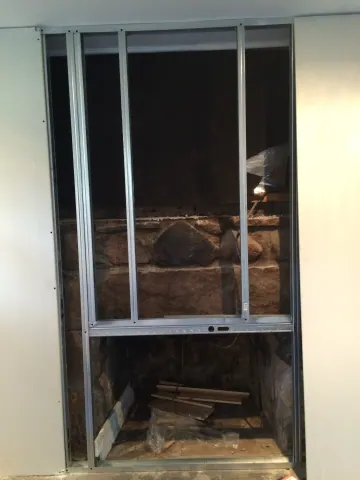 Framed fireplace wall before finishing