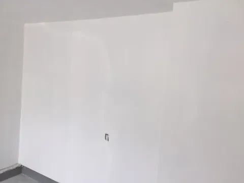 Finished white garage wall and skirting