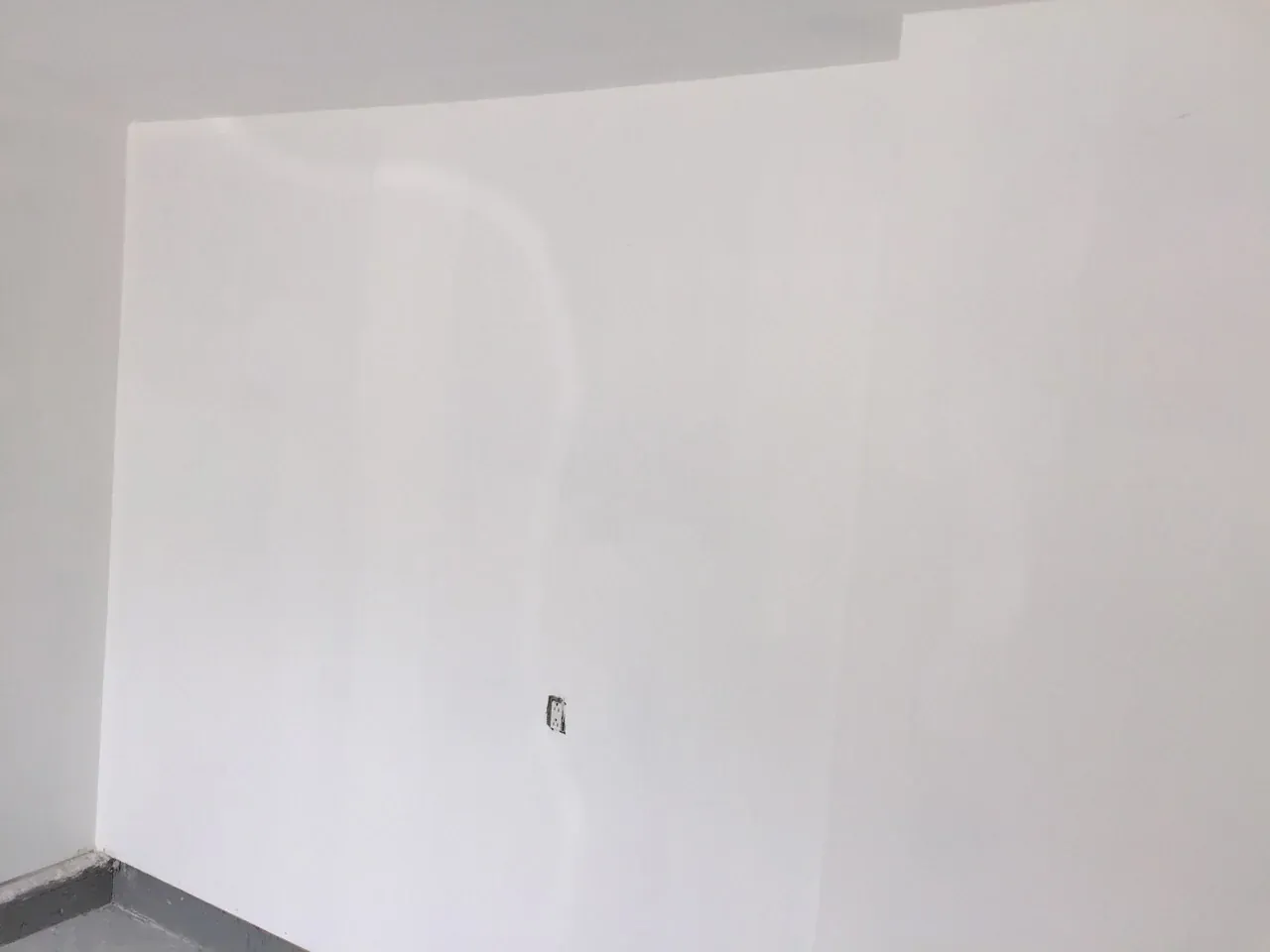 Finished white garage wall and skirting