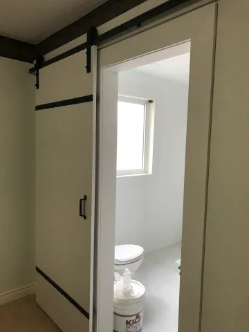 Sliding door opening into the renovated bathroom