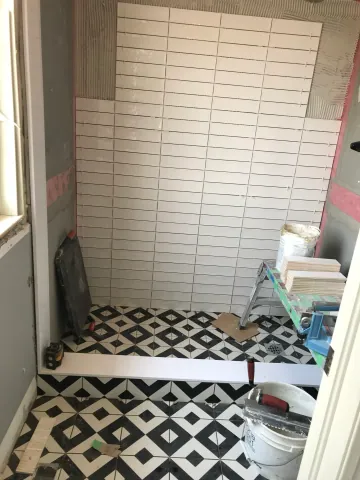 Patterned floor and shower tile during bathroom renovation