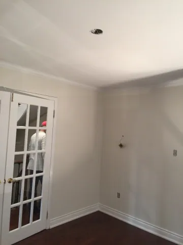 Freshly finished living room with dark timber flooring and French doors