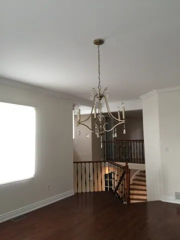 Living room with dark hardwood flooring and timber stair railings