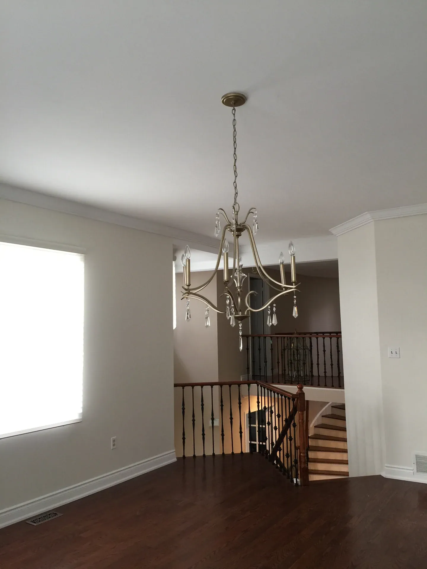 Living room with dark hardwood flooring and timber stair railings