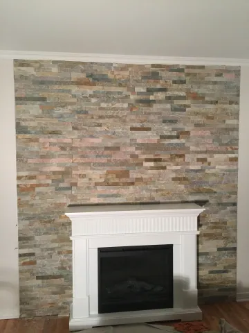 Stacked stone fireplace surround with white mantel