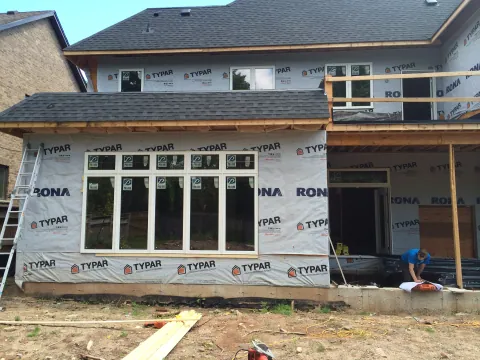 Home addition at the sheathing and window installation stage