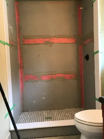 Waterproofed shower enclosure before wall tiling