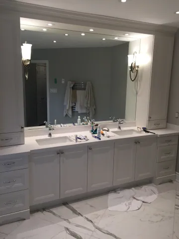 Grey double vanity with a wide mirror and vanity lighting