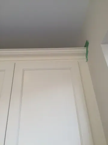 Crown moulding above white kitchen cabinetry