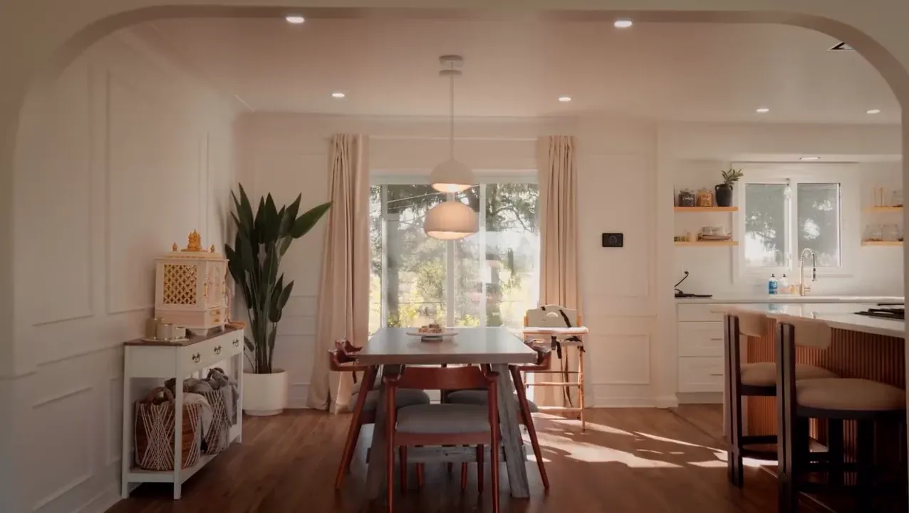 Light-filled kitchen and dining area with white cabinetry, timber details and brass fittings